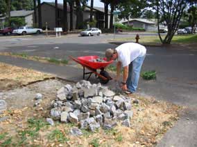 Loading concrete rubble into wheelbarrow