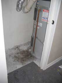 Water in hot water heater closet