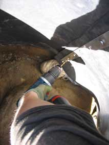 Drilling pilot hole for bolt and nut to hold barrier together
