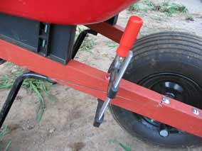 Clamp holding broken wheelbarrow arm together