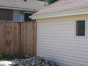 Fence tying back to southeast corner of garage