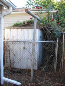 Old clothesline pole behind the garage