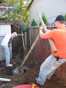 Trying to get the clothesline pole out of the hole