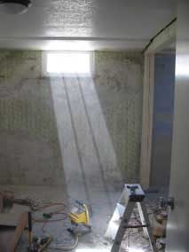 Sunlight highlights clouds of dust in the basement