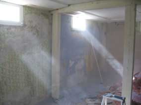 Sunlight highlights clouds of dust in the basement