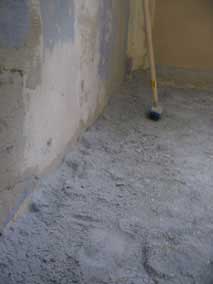 Scraping wallpaper off the concrete walls