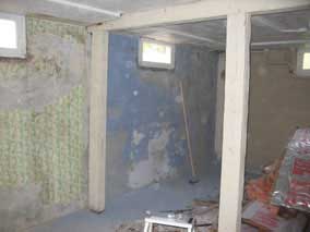 Scraping wallpaper off the concrete walls
