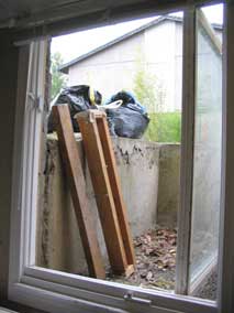 Demolition debris piled up in egress well waiting to be hauled off