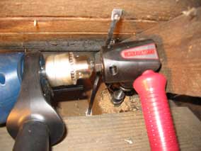 Drilling for electrical wiring in the garage attic