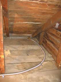 Electrical wiring in garage attic enclosed in conduit
