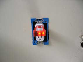 Tester checking out ok in ceiling receptacle