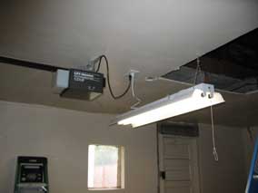 Fluorescent light and garage door opener plugged in and working