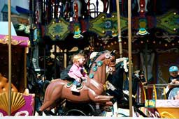 Cute girl on Venetian Carousel at Pier 39