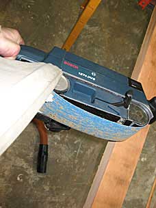 Shirt tail caught in belt sander