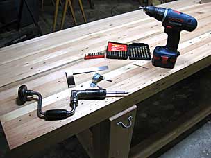 Attaching half-round metal bracket to back leg of workbench