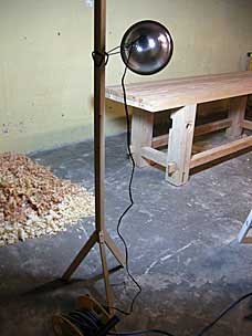Wooden stand for clamp work light to provide raking light
