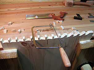 Sawing dovetail waste with coping saw