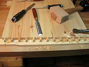 Paring waste between pins on tool chest side