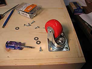 Attaching caster to bottom of tool chest