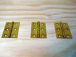Brass hinges after sanding away Brass Black