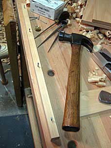 Driving cut nails into bottom runner