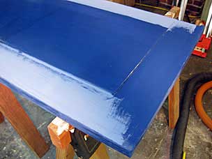 Final coat of milk paint on tool chest lid