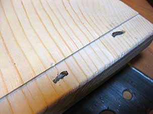 Clinched nails through batten and lid