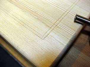 Layout lines scored for decorative groove in lid