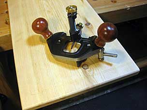 Router plane set up to plow decorative groove in lid