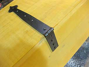 Boarded chest strap hinge with nails